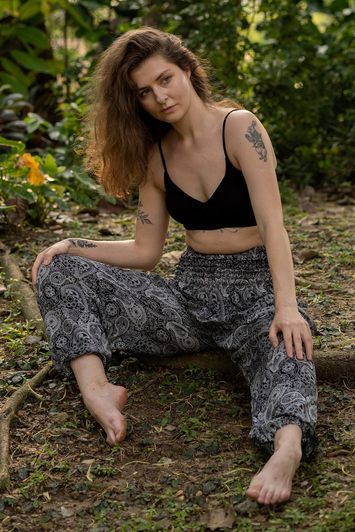 Black-and-gray paisley rayon flow pants, wide legs, ankle length, worn