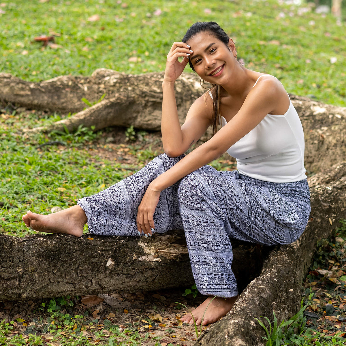 Gray printed rayon pants with draped relaxed legs and ankle cuffs