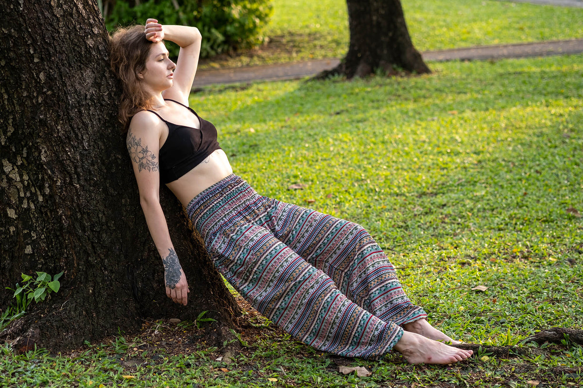 Multicolor patterned rayon pants with wide legs and elastic waist, laid-out side view