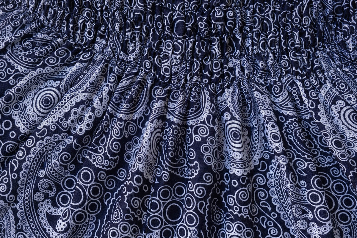 Close-up of dark blue fabric with white paisley pattern for flow pants